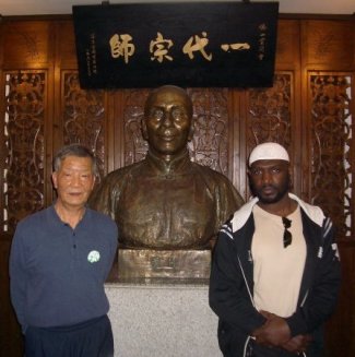 Grand Master Ip Ching and Sifu Garry McKenzie beside the bust of Grand Master Ip Man at the Ip Man Tong